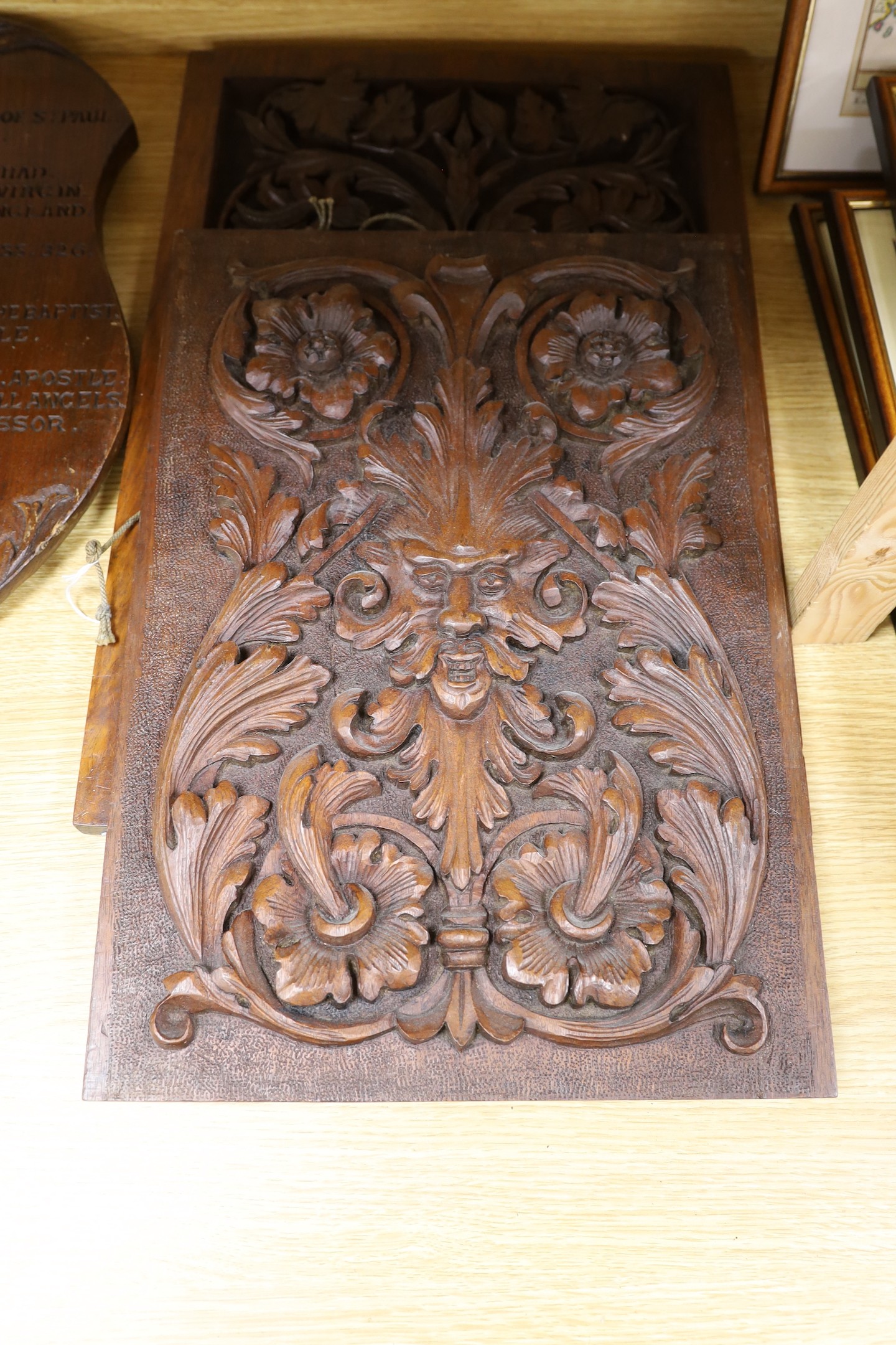 Six mixed oak carved panels and a metal relief mounted panel